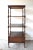 A vintage dark wood mahogany rolling etagere, whatnot, or set of 4 display shelves, in the English Regency style, with...