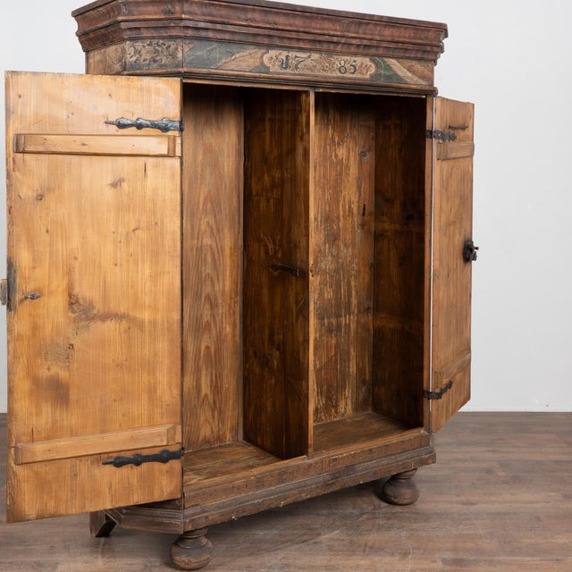 Original hand-painted Austrian pine armoire dated 1785. The cabinet retains its original painted finish in soft teal, pale...