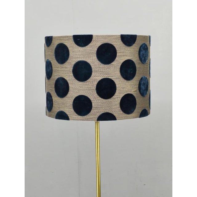 Elegant hollywood regency floor lamp produced in italy during the 1950s. This refined lighting piece features a slender...