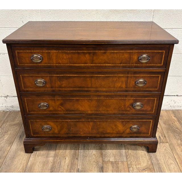 This is a stunning vintage Georgian style Chippendale flame mahogany banded satinwood side chest of drawers or bachelor’s...