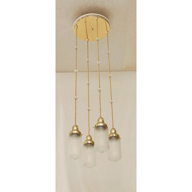 Art Nouveau Chandelier Art Nouveau lamp made around 1915. Large, smooth brass ceiling plate. Mounted on a white lacquered...