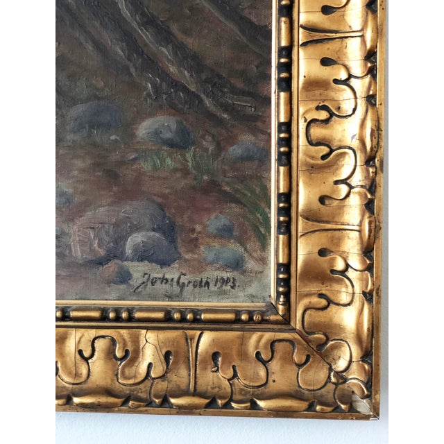 A vintage original oil painting of a seascape, dated 1923. The painting shows a sandy shoreline, scattered rocks, wind-...