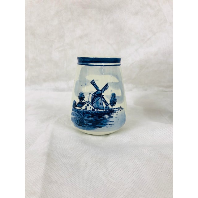 Wide mouth Delft jar with windmill scene on one side and feather on other. Cross hatches adorn each side. Perfect for...