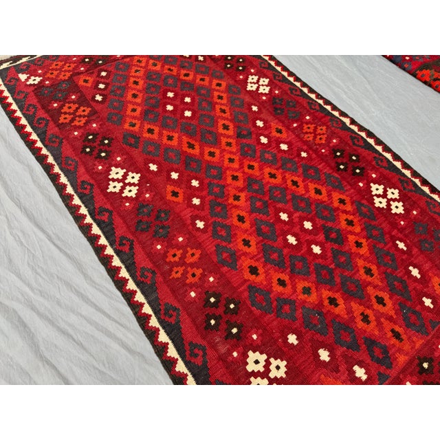 This 3'4" × 6'4" (102 × 193 cm) vintage Afghan handwoven kilim rug features a striking tribal diamond pattern in bold hues...