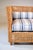 A double cane solid teak settee with newly upholstered seat & back bolster cushions in blue and white stripe Sunbrella...