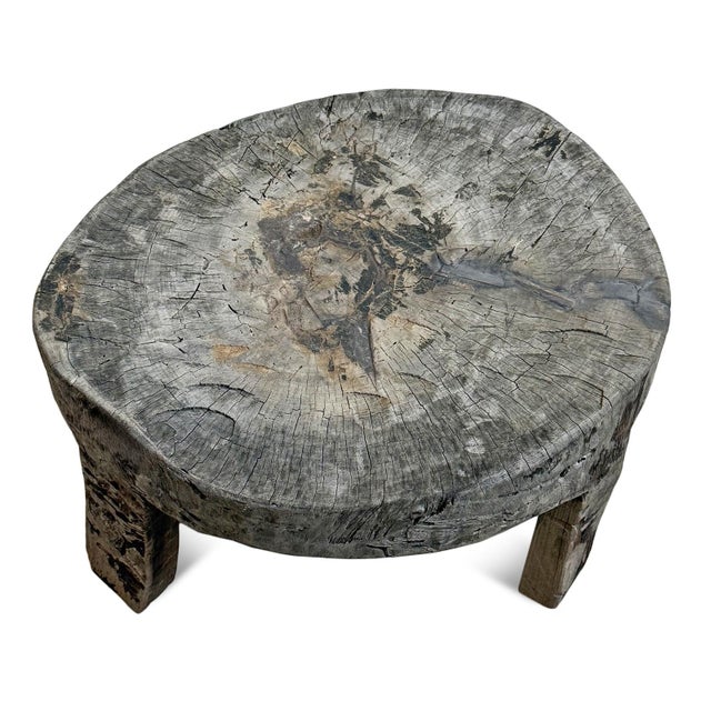 Sculptural early 20th century Naga low table, hand-hewn from a single solid timber section and raised on integrated block...