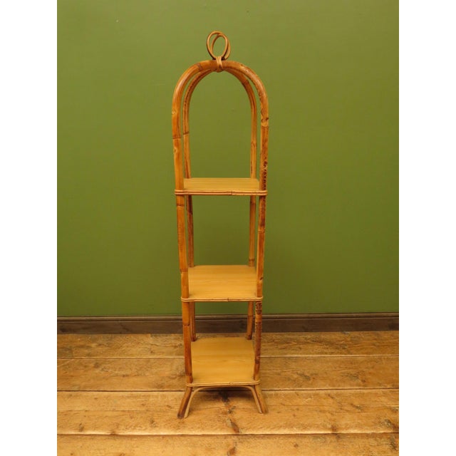 A useful tiered stand dating to the mid 20th Century. The stand is made of bamboo and mixed woods, it is an attractive...