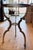 A beautifully designed Ethan Allen accent table featuring an inset glass top and sculptural metal base finished in a soft...