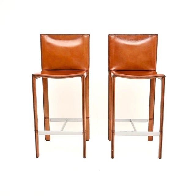 A beautiful pair of vintage Italian leather bar stools by Enrico Pellizzoni. They were made in Italy and date from around...