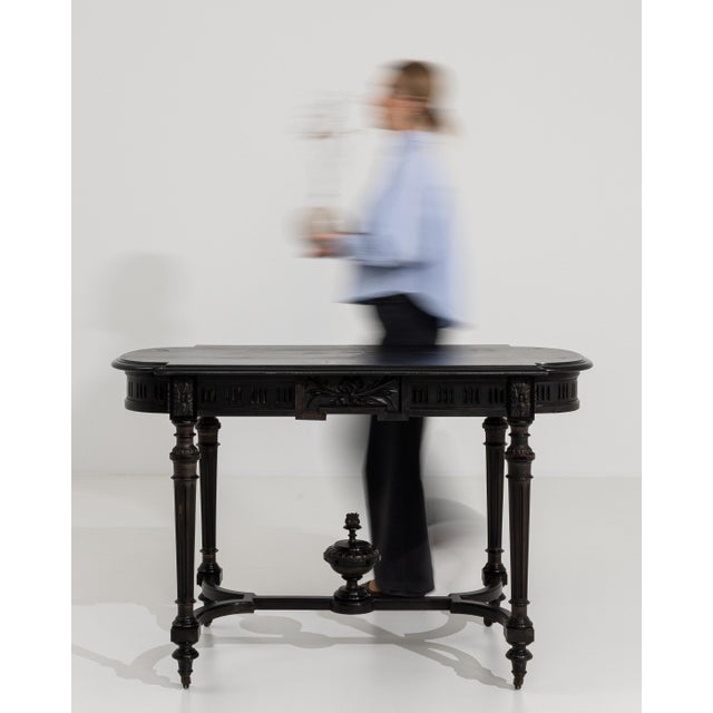 A refined center table from the Napoleon III period, combining decorative detail with functional design. The gently shaped...