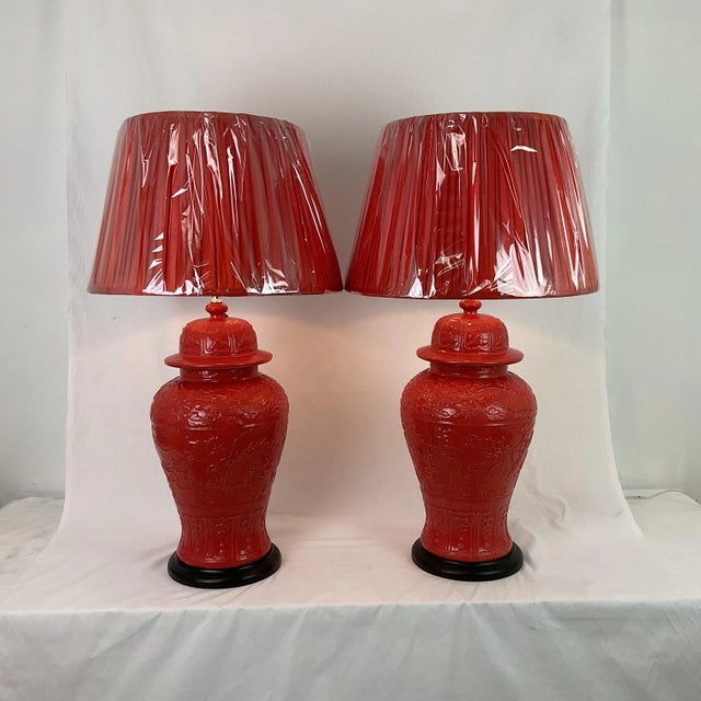 A striking pair of 1960s vintage porcelain ginger jar lamps, finished in a vibrant coral glaze that brings bold color and...
