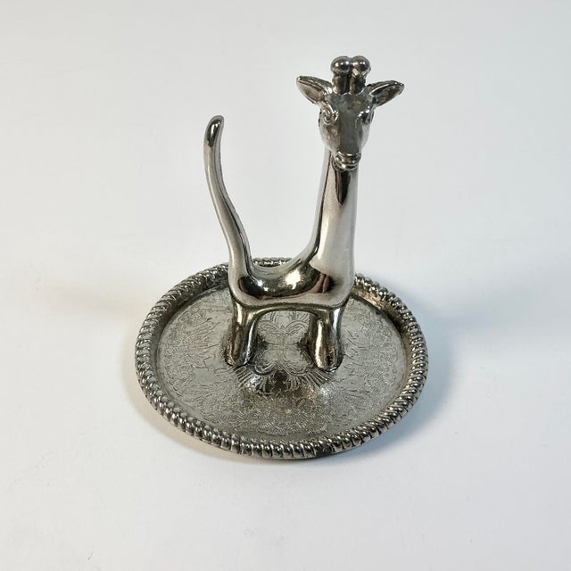 A fun and whimsical ring catchall from the Mid-Century. It’s a silver colored metal with a figurative Giraffe on a petite...