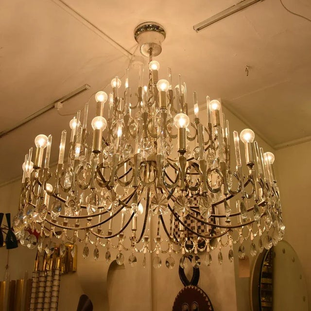 This large silver-plated chandelier with cut crystal glass details was designed by Gaetano Sciolari in the 1970s. This...
