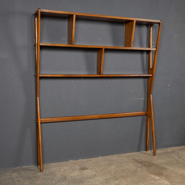 A mid-20thC Italian bookcase in a beautifully curved beechwood frame. This piece can also be used as a room divider. A...