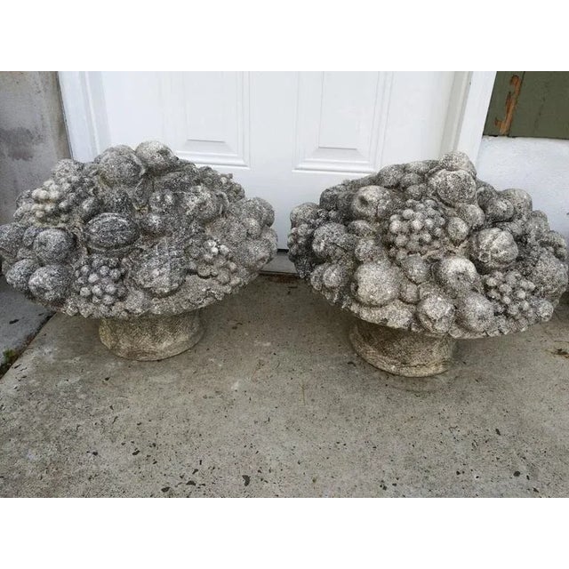 Monumental pair of Vintage stone fruit and flower baskets. Lovely aged patina to these beautiful detailed bouquets. These...