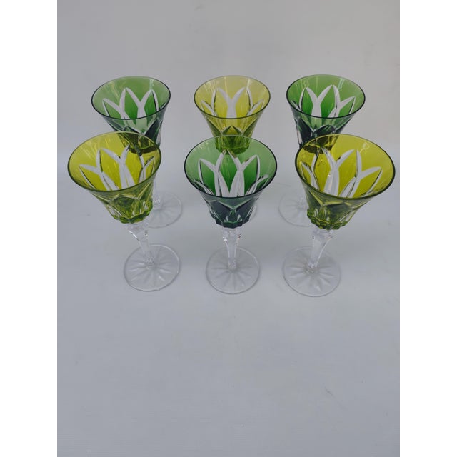 Six large Saint Louis crystal glasses, Camargue pattern. Three are chartreuse green and three are forest green. They are...