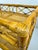 A distinctive vintage bamboo and cane bar cart featuring two woven cane shelves, decorative geometric fretwork, and a...