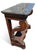 This piece of furniture is a French Second Empire / Charles X period mahogany console table featuring a variegated gray...