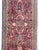 A traditional early 20th century Persian Sarouk rug with a mirrored floral pattern woven with myriad flowers and scrolling...