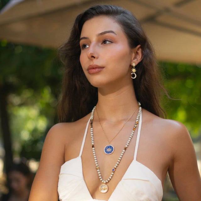 Step into the mystical cosmos with the Cosmic Evil Eye Star Medallion Gold Necklace, a powerful symbol of protection and...