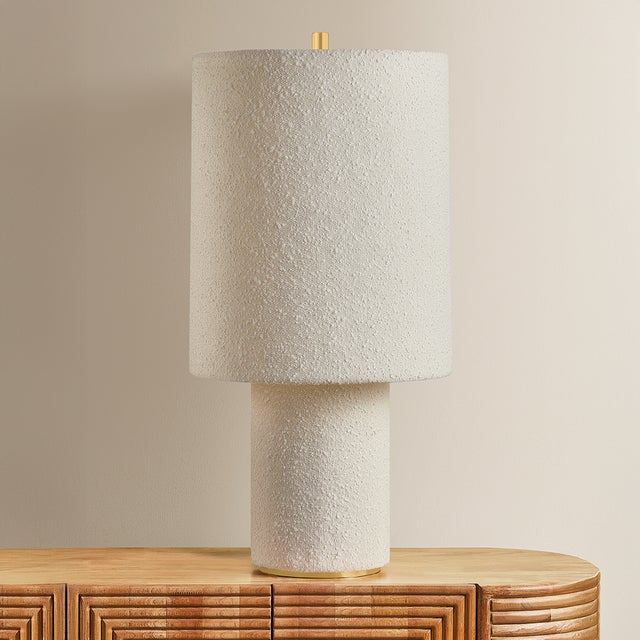 The all-over soft ivory boucle of the Sam family of lamps creates an inviting addition to modern interiors. As a table...