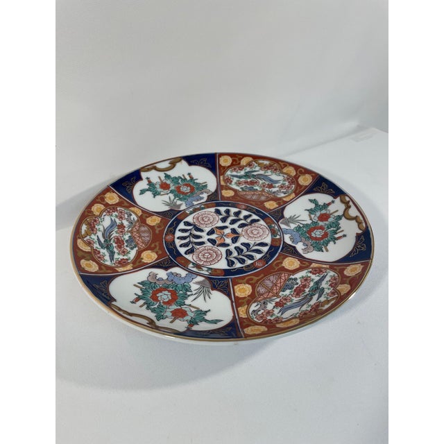An elegant Japanese "Kinrande" (gold brocade) Gold Imari porcelain charger plate dating to the 1950s. Maker's stamp on the...
