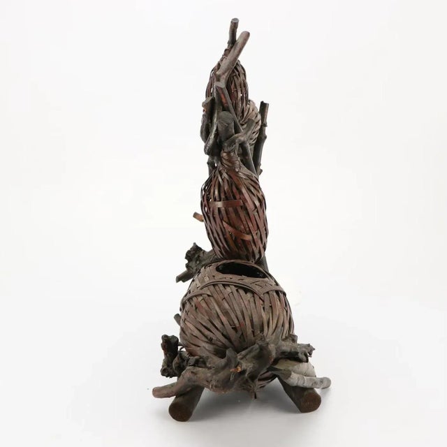 A gourd form ikebana basket The unsigned two-section basket designed as a large and small double gourd cradled in a...