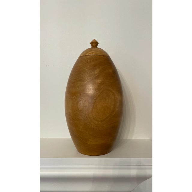 The ovoid shape and clean lines of this solid wood turned urn could transition from a traditional to contemporary style...