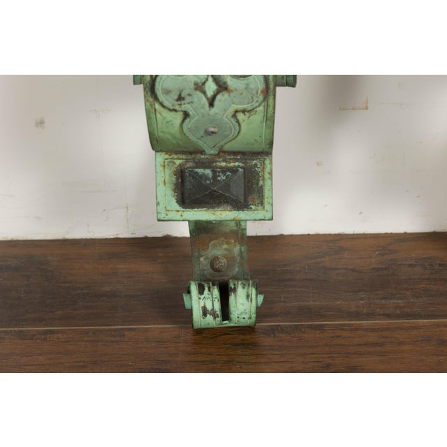 A pair of English bronze wall brackets from the 19th century with lucite tops, scrolling motifs and verdigris patina....