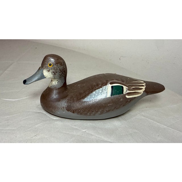 This vintage 1983 hand carved wood Clarence Bauer miniature duck decoy sculpture is a unique and collectible piece of art....