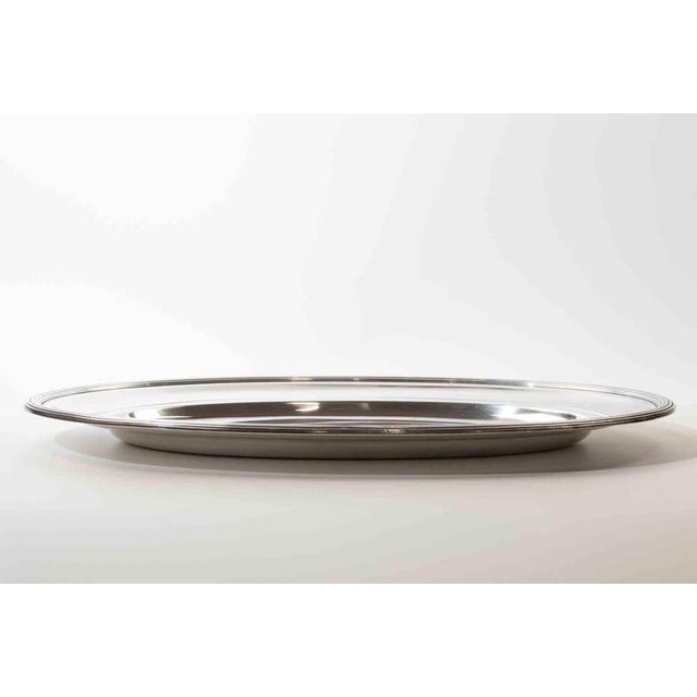 Elegant large oval serving tray crafted in polished silver plate with a refined minimalist profile and classic stepped...