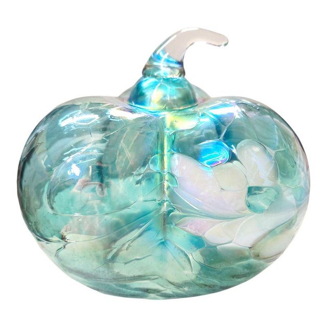 A stunning sculptural art glass pumpkin featuring an unusual three-lobed silhouette, luminous aqua blue and seafoam green...