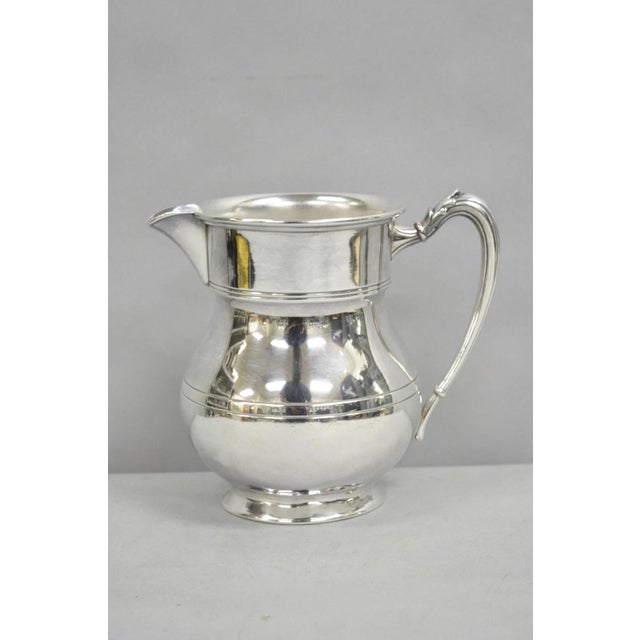 Vintage Victorian Silver Plated Pewter Bulbous Lemondade Water Pitcher with Fancy Handle. Circa Mid 20th Century....