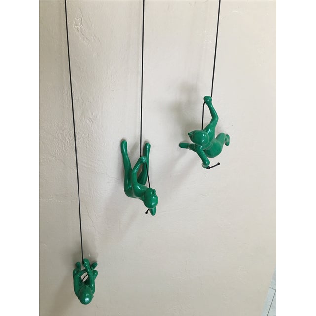 Offered is a three-piece wall-mount sculpture of men climbing a rope. Crafted from resin in a rich green color. Looks...