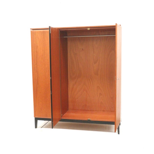 Vintage 3-door wardrobe with hanging and shelving units, made in the 1960s. Practical vintage 3-door wardrobe from the...