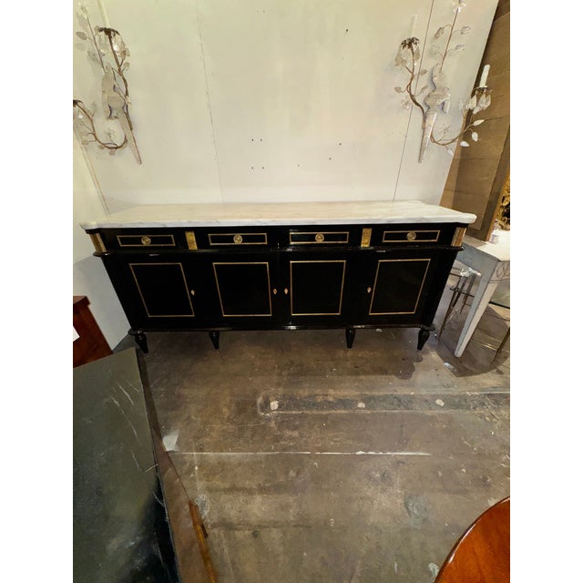 The French Louis XVI Style Black Lacquered Sideboard is a luxurious and stylish piece of furniture that exudes elegance...