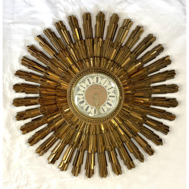 Mid Century Modern Syroco Starburst wall clock circa 1969. This stylish piece is made of cast plastic in an antique gold...