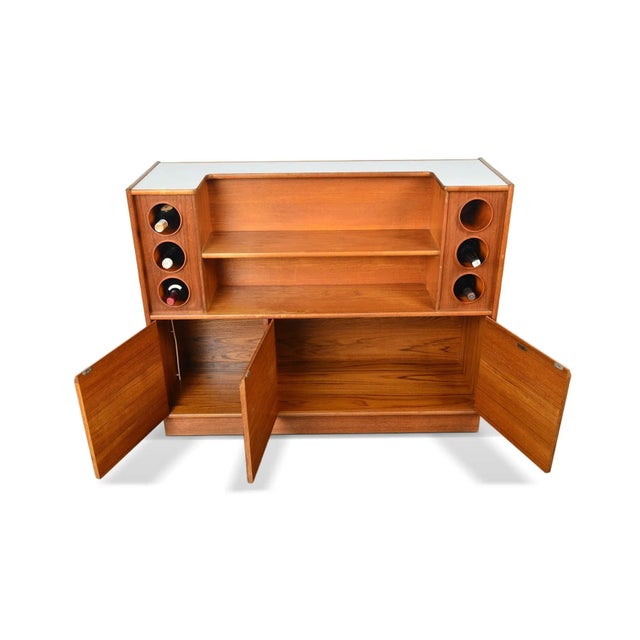 Origin: England Designer: Unknown Manufacturer: Turnidge of London Era: 1960s Materials: Teak, Laminate Measurements: 48"...