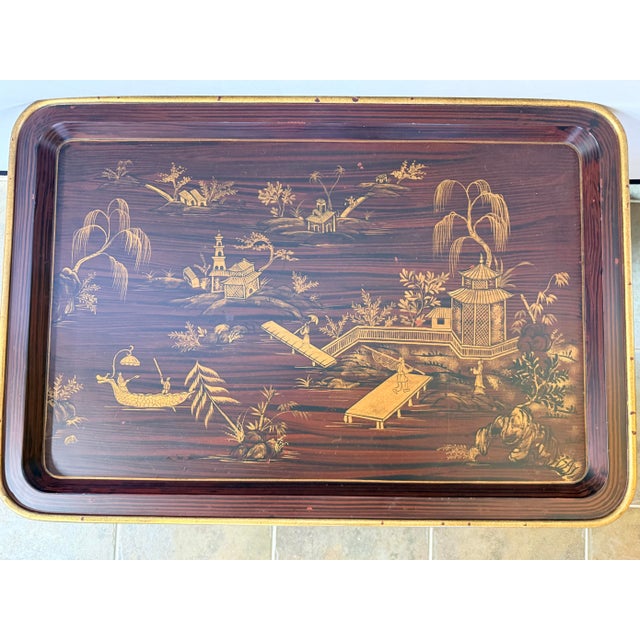 A striking chinoiserie coffee table with an intricately decorated tray-form top, featuring a serene pagoda-and-garden...