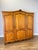 A beautifully presented Vintage French Louis wardrobe in oak, featuring three panelled doors, a graceful shaped top and...