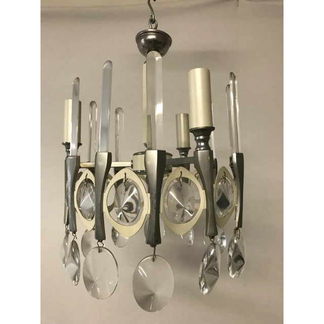 This vintage Italian chandelier is made of crystal and chrome. It features three light sockets. This piece is designed in...