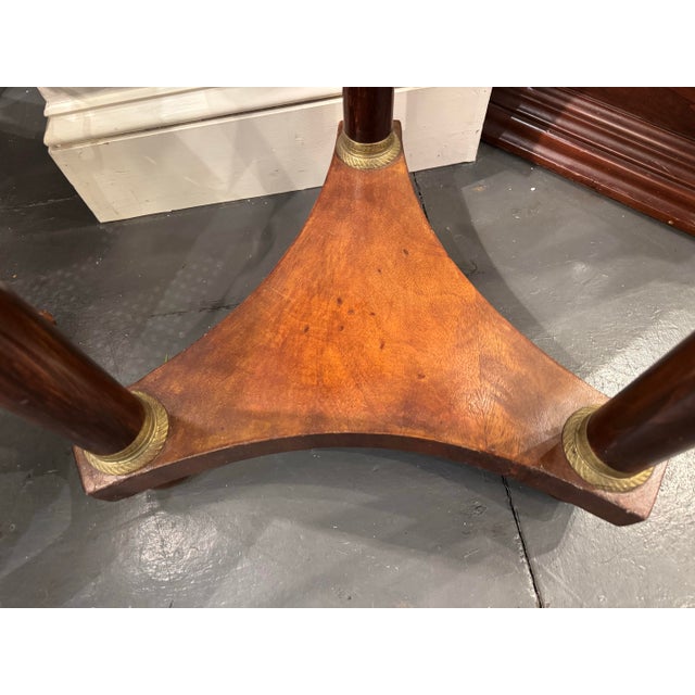 This is a 19th Century Antique Marble Top Round Side Table. It is French. It is empire style. It has walnut wood. The...