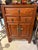 Vintage cinnabar toned Asian cabinet with three drawers and one lower cupboard. Sturdy little cabinet for the right place.