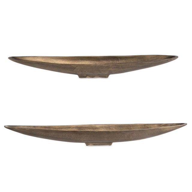 Featuring a sleek, elongated silhouette and an antiqued brass finish, this cast aluminum boat bowl brings sculptural...