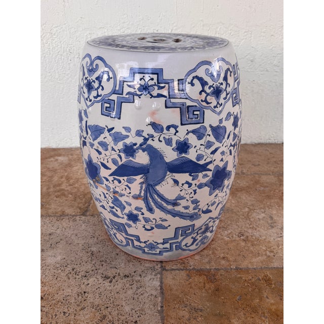 Vintage Chinese garden stool crafted in glazed terracotta, featuring a classic blue and white palette with traditional...