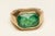 A stunning emerald-cut, faceted 5 carat emerald set in a beveled 18K gold band. Ring size is a 7. Classic and elegant. The...