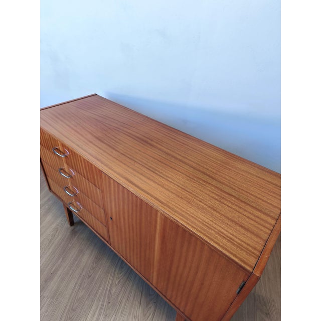 A modernist long sideboard of the 1970s. A simple, minimalist sideboard. Capacious. Drawers and shelves. Original...