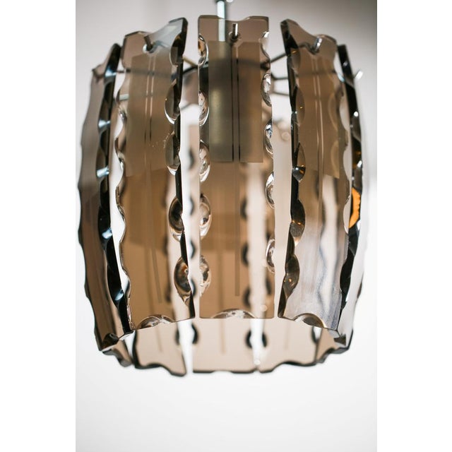 Vintage chandelier was made by VECA in Italy in the 1970s. Its made from metal structure and brown murano glass enlogated...