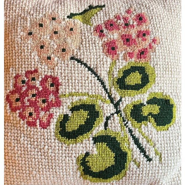 Vintage botanical needlepoint flower pillow showing pink geraniums and green leaves. Executed with a combination of small...