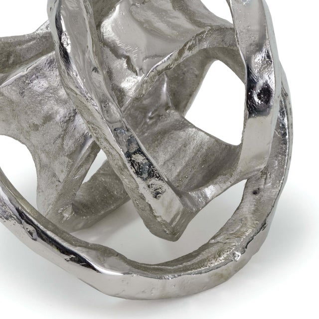 This abstract sculptural object wears a polished nickel finish and has a real, handmade quality, perfect to dress up a...